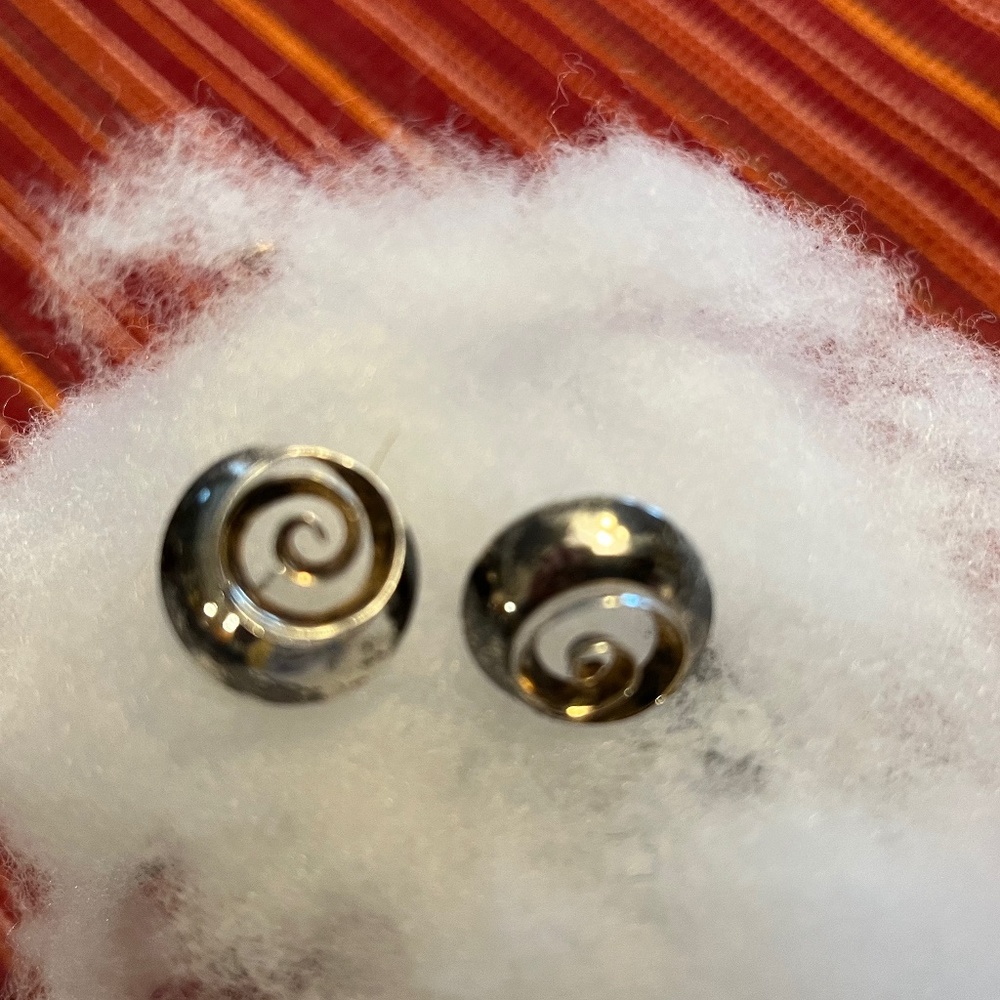 Sterling silver with 14K gold inside inner swirl